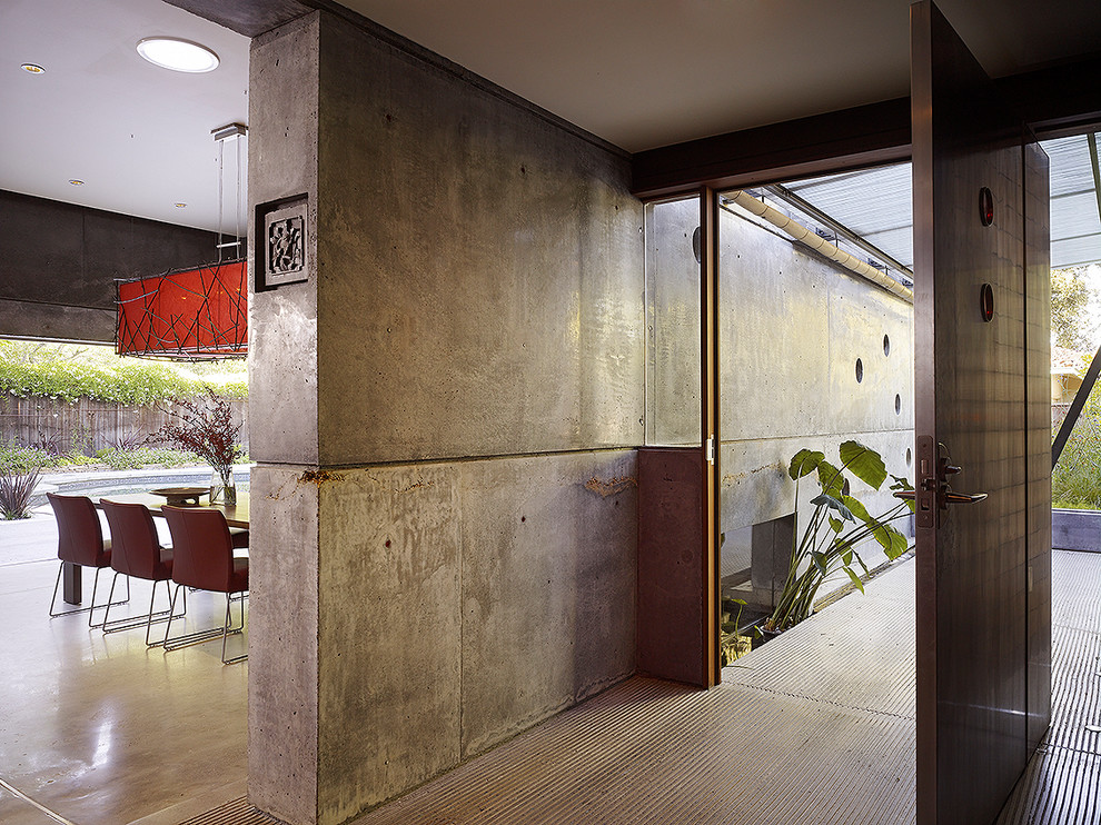Inspiration for a large contemporary concrete floor entryway remodel in San Francisco with a metal front door