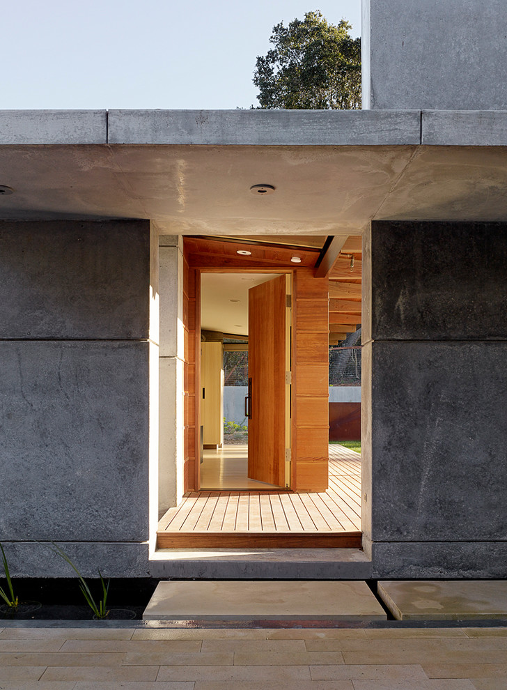 Entryway - large contemporary medium tone wood floor and brown floor entryway idea in San Francisco with gray walls and a medium wood front door