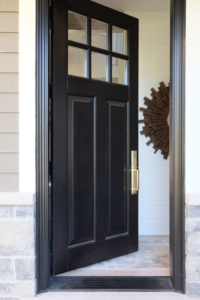 Photo of a medium sized beach style front door in Toronto with white walls, light hardwood flooring, a single front door, a black front door and brown floors.