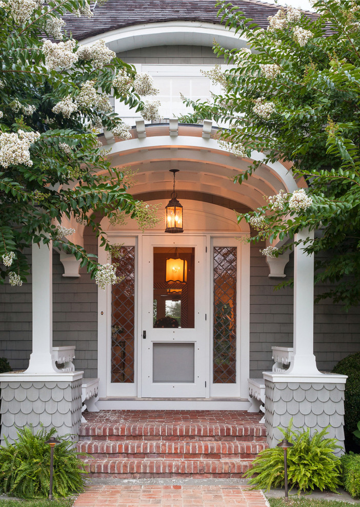 Traditional front door in New York with feature lighting.