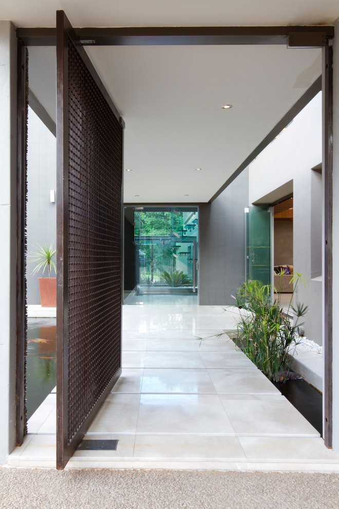 Inspiration for a large contemporary front door in Other with a pivot front door.