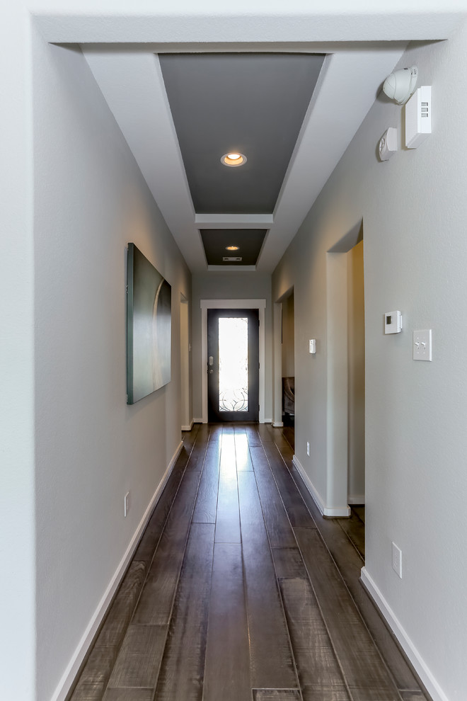 Inspiration for a mid-sized transitional medium tone wood floor and brown floor hallway remodel in Houston with gray walls