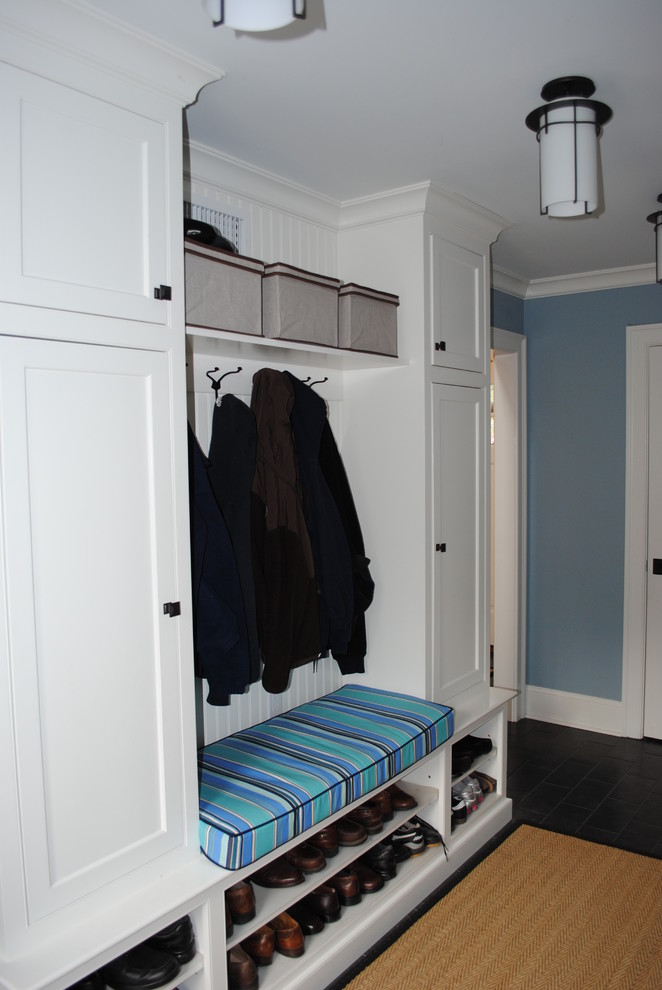 Example of a mid-sized classic slate floor entryway design in New York with blue walls and a white front door