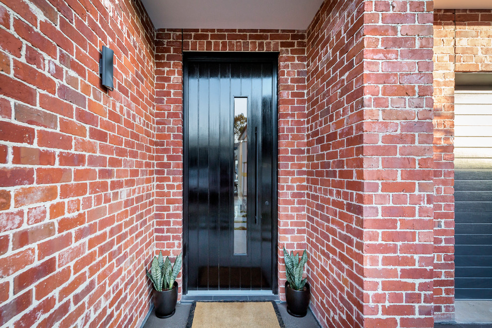 This is an example of a large contemporary front door in Adelaide with red walls, porcelain flooring, a single front door, a dark wood front door and grey floors.