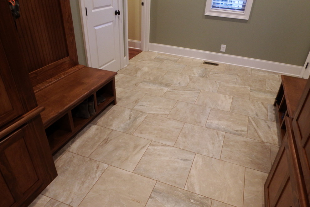 Mudroom - mid-sized traditional porcelain tile mudroom idea in Other with green walls