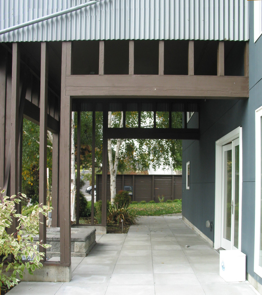 Example of a large urban limestone floor entryway design in Seattle with blue walls and a glass front door