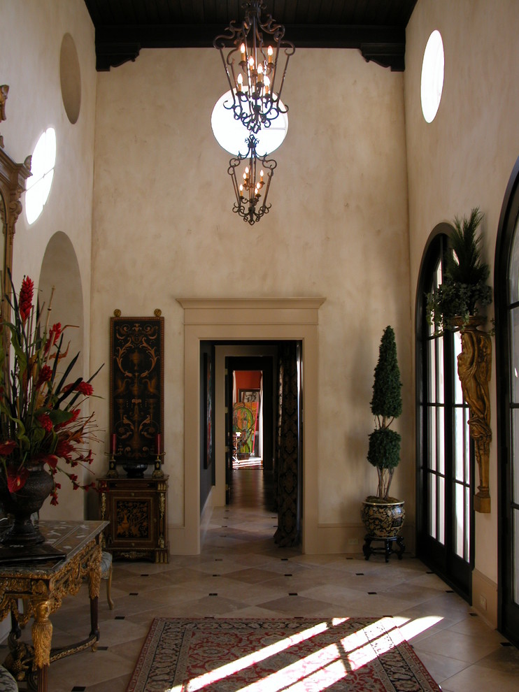 Inspiration for a mid-sized mediterranean ceramic tile entryway remodel in Miami with beige walls and a brown front door