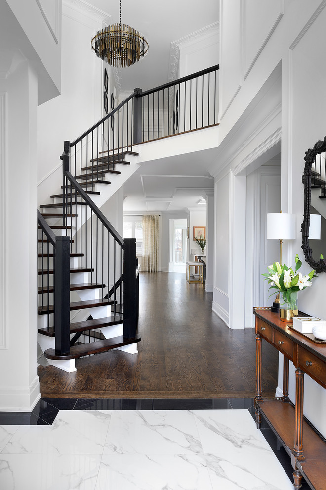 Example of a transitional marble floor and gray floor entryway design in Toronto with white walls