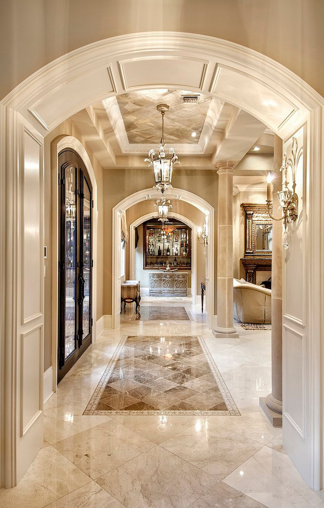 Inspiration for a large timeless marble floor double front door remodel in Other with a dark wood front door