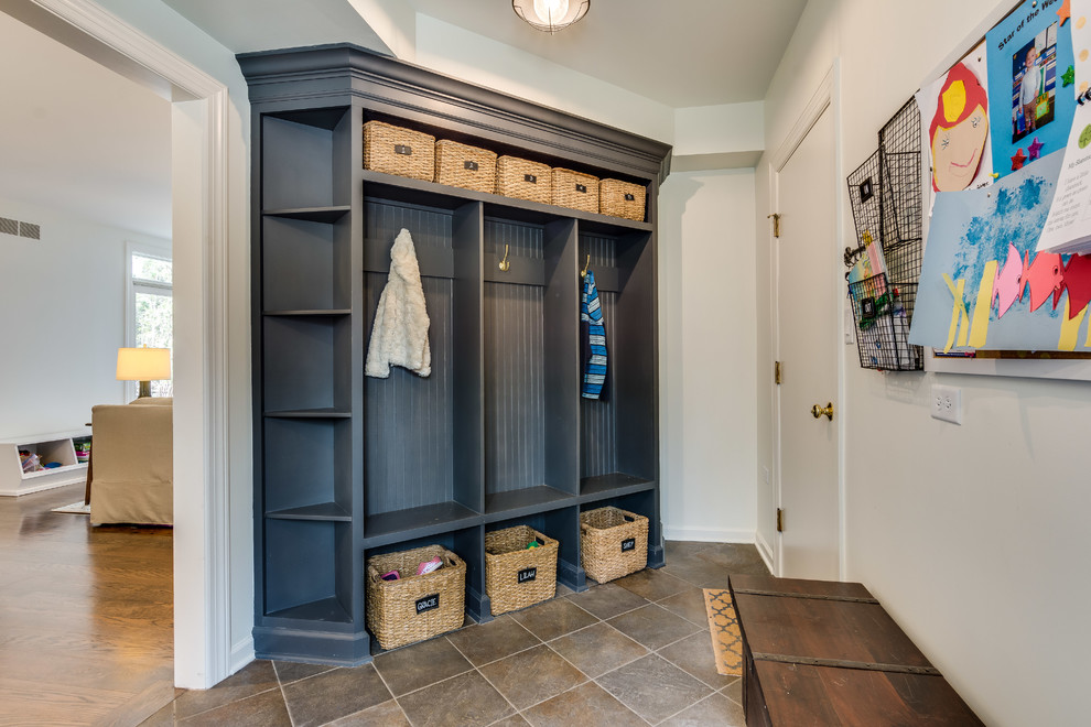 Mudroom - transitional gray floor mudroom idea in Chicago with white walls