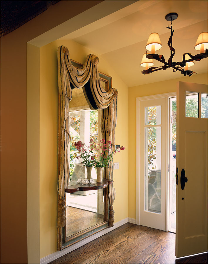 Пример оригинального дизайна: входная дверь среднего размера в викторианском стиле с желтыми стенами, паркетным полом среднего тона, одностворчатой входной дверью, белой входной дверью и коричневым полом