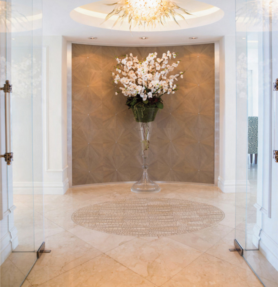 Entryway - large modern marble floor entryway idea in Miami with white walls and a glass front door