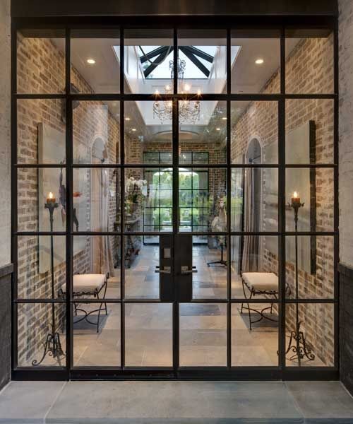 На фото: большая входная дверь в стиле лофт с бетонным полом, двустворчатой входной дверью и стеклянной входной дверью с