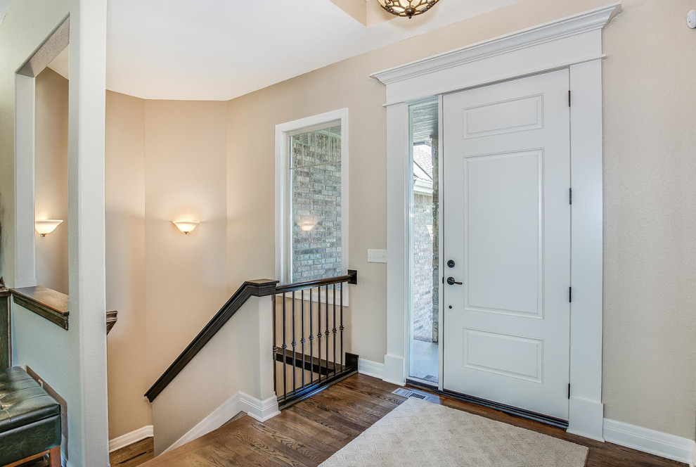 Photo of a small contemporary front door in Orange County with beige walls, medium hardwood flooring, a single front door and a white front door.