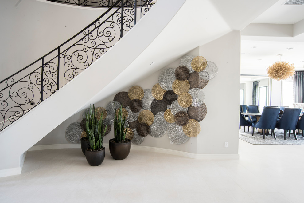 Inspiration for a mid-sized contemporary limestone floor and white floor foyer remodel in Orange County with gray walls