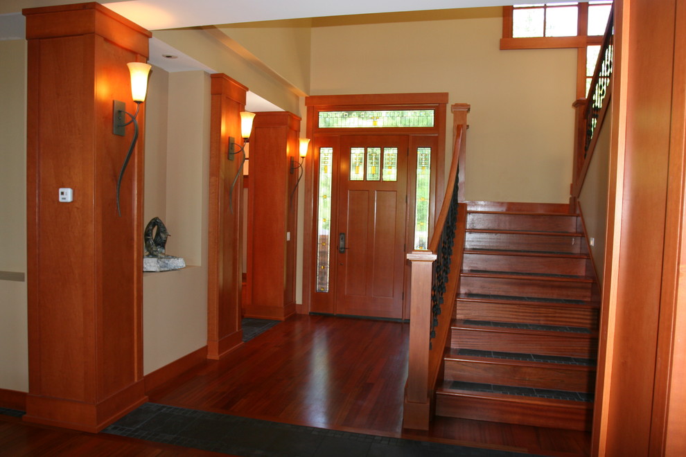 Inspiration for a mid-sized craftsman medium tone wood floor entryway remodel in Seattle with beige walls and a medium wood front door
