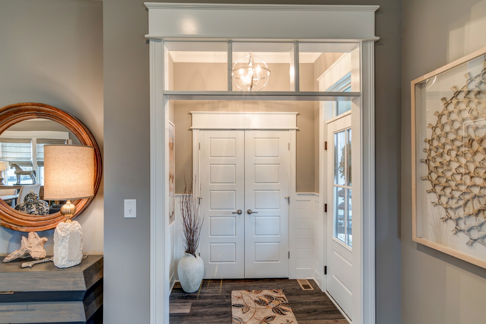 Inspiration for a craftsman dark wood floor entryway remodel in Indianapolis with beige walls and a white front door