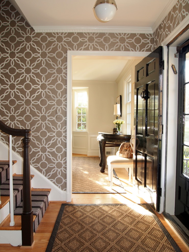 Example of a classic medium tone wood floor single front door design in Baltimore with a black front door