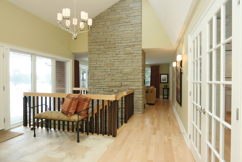 This is an example of a medium sized contemporary foyer in Toronto with beige walls and light hardwood flooring.