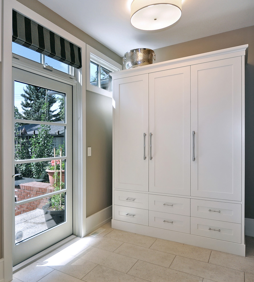 Inspiration for a traditional boot room in Calgary with beige walls, a single front door and a glass front door.