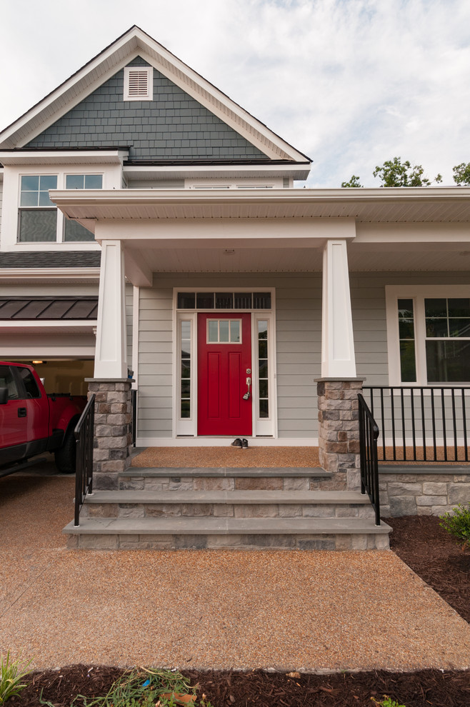 Esempio di una porta d'ingresso stile americano di medie dimensioni con una porta singola e una porta rossa