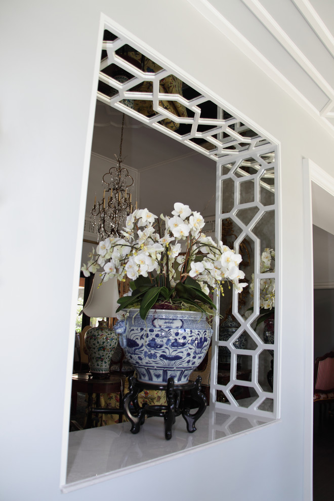 Example of an asian marble floor entryway design in Miami with gray walls and a red front door