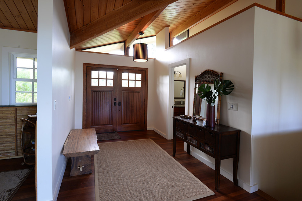 Mid-sized island style dark wood floor and brown floor entryway photo in Hawaii with white walls and a medium wood front door