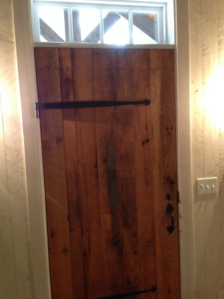 Design ideas for a rustic front door in New York with a single front door and a medium wood front door.