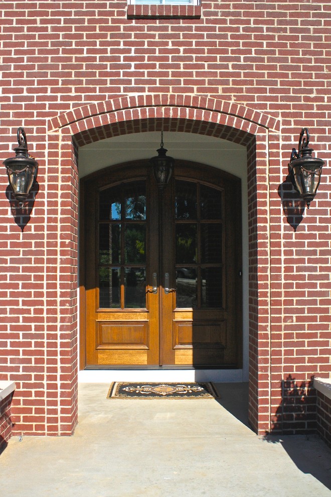 This is an example of a medium sized traditional front door in St Louis with a double front door and a medium wood front door.
