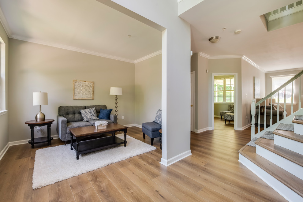 This is an example of a large contemporary foyer in Baltimore with vinyl flooring, yellow floors and white walls.