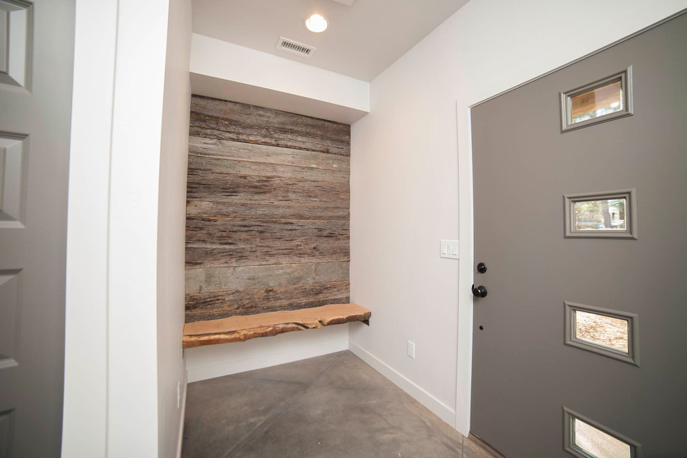 Design ideas for a small rustic foyer in Phoenix with white walls, concrete flooring, a single front door and a metal front door.