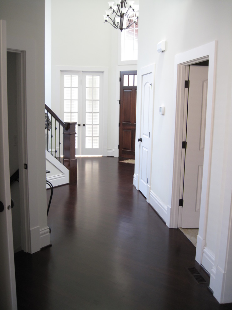 Inspiration for a medium sized classic hallway in Seattle with white walls, dark hardwood flooring, a single front door and a dark wood front door.
