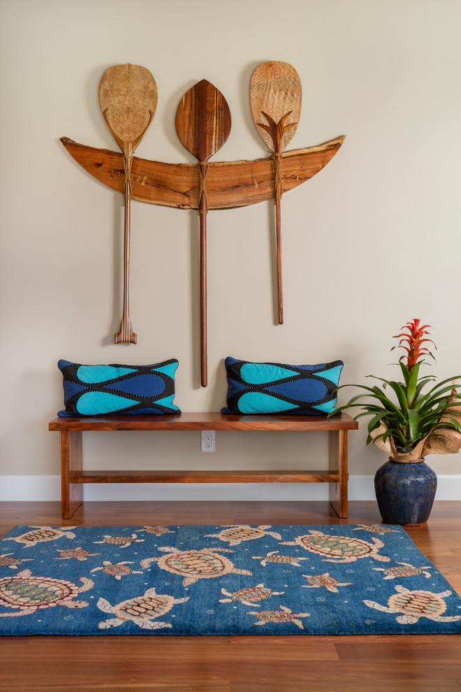 Mid-sized island style dark wood floor and brown floor entryway photo in Hawaii with beige walls and a glass front door