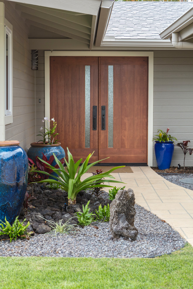 Inspiration for a large world-inspired front door in Hawaii with grey walls, a double front door and a dark wood front door.