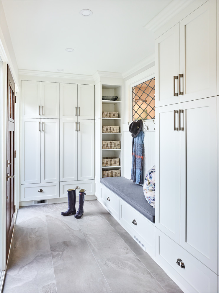 Small transitional porcelain tile and gray floor entryway photo in Vancouver with white walls and a dark wood front door