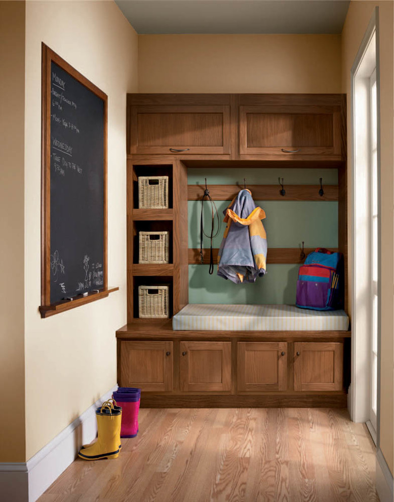 Mid-sized elegant light wood floor and brown floor mudroom photo in Jacksonville with beige walls