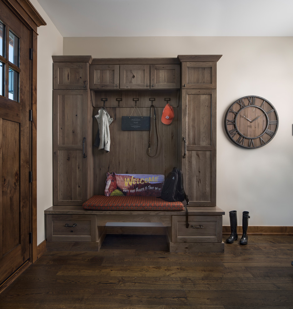 Example of a mountain style medium tone wood floor and brown floor entryway design in Other