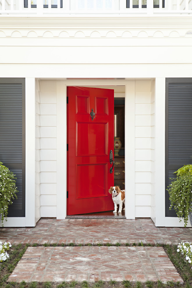 Entryway - mid-sized coastal entryway idea in San Diego with a red front door