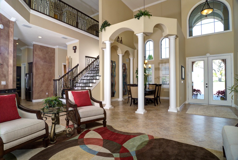 Photo of a mediterranean entrance in Orlando with beige walls, ceramic flooring, a double front door and a glass front door.