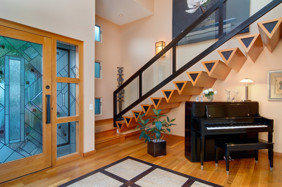 Foyer - contemporary foyer idea in San Diego with beige walls and a glass front door