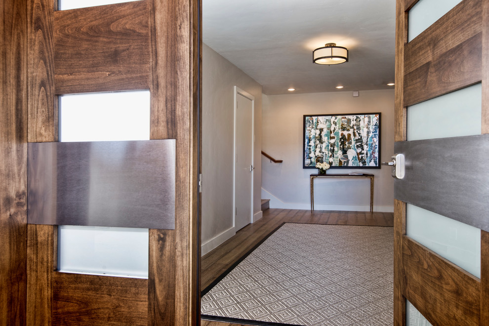 Expansive traditional foyer in Denver with beige walls, medium hardwood flooring, a double front door and a medium wood front door.