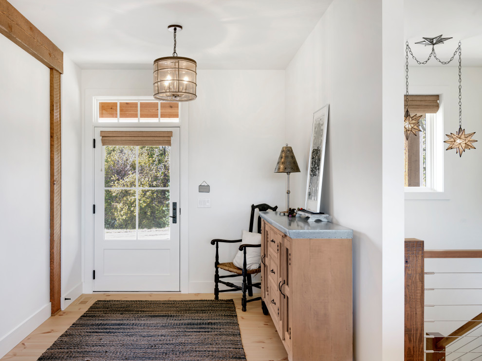 Mid-sized cottage light wood floor and brown floor entryway photo in Minneapolis with white walls and a white front door