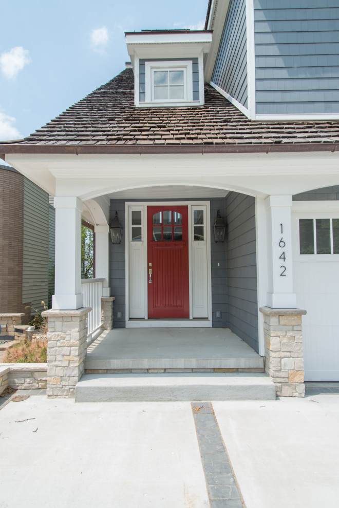 Example of a mid-sized arts and crafts entryway design in Chicago with blue walls and a red front door