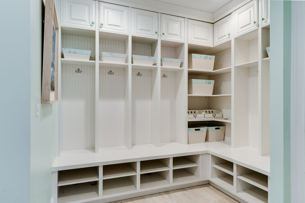 Mudroom - mid-sized traditional mudroom idea in Charlotte with white walls