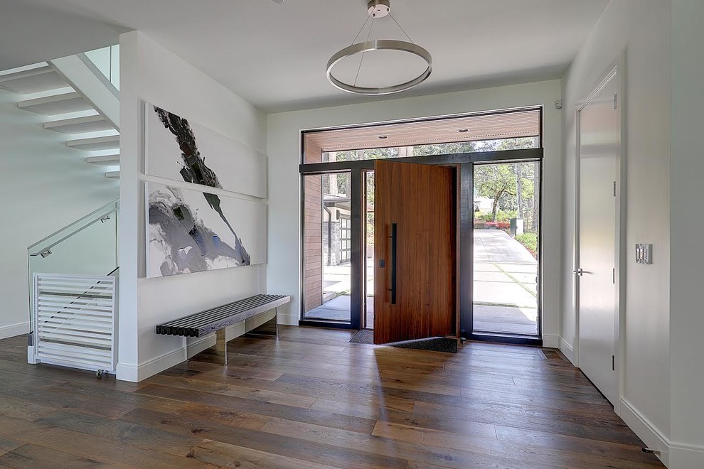 Inspiration for a large contemporary medium tone wood floor and brown floor entryway remodel in Portland with orange walls and a medium wood front door