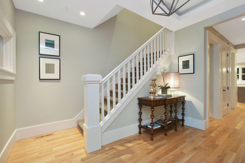Example of a large transitional medium tone wood floor and brown floor foyer design in San Francisco with beige walls