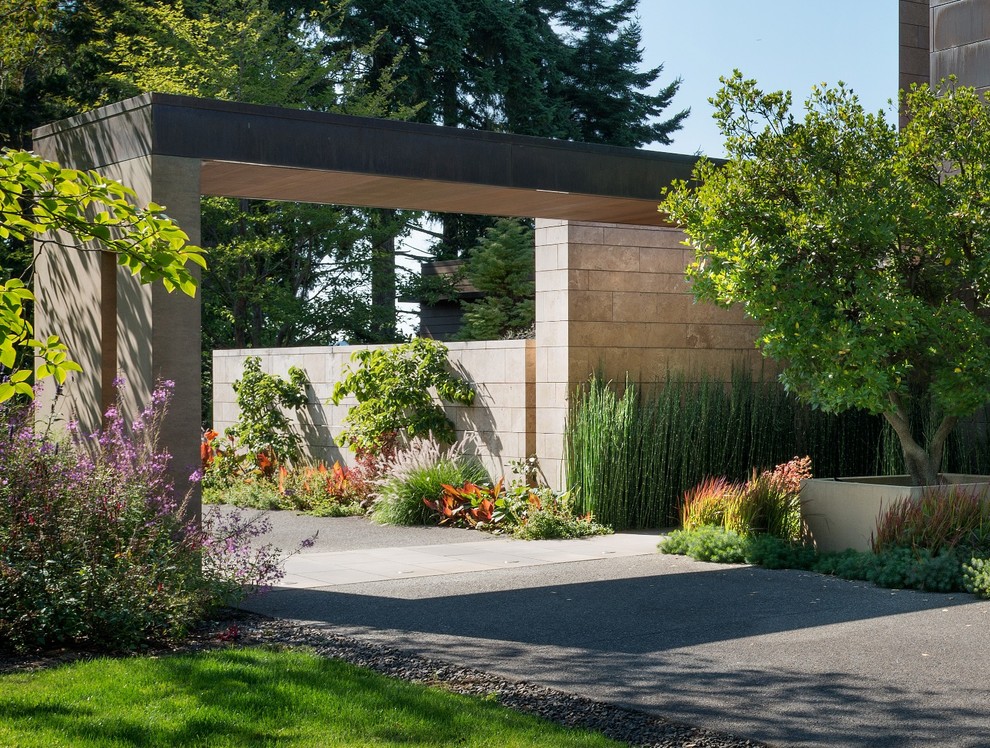 Photo of a medium sized contemporary entrance in Seattle with concrete flooring, a pivot front door and a metal front door.