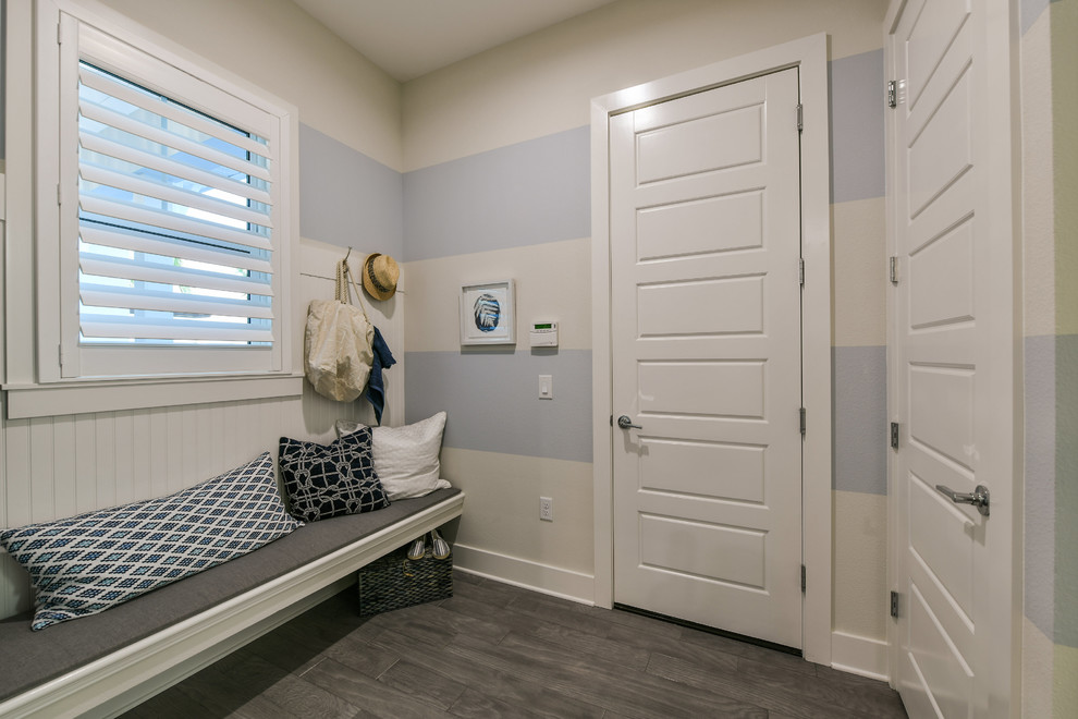 Mid-sized beach style mudroom photo in Other with multicolored walls