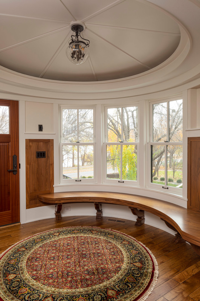 Mid-sized elegant dark wood floor and brown floor entryway photo in Minneapolis with white walls
