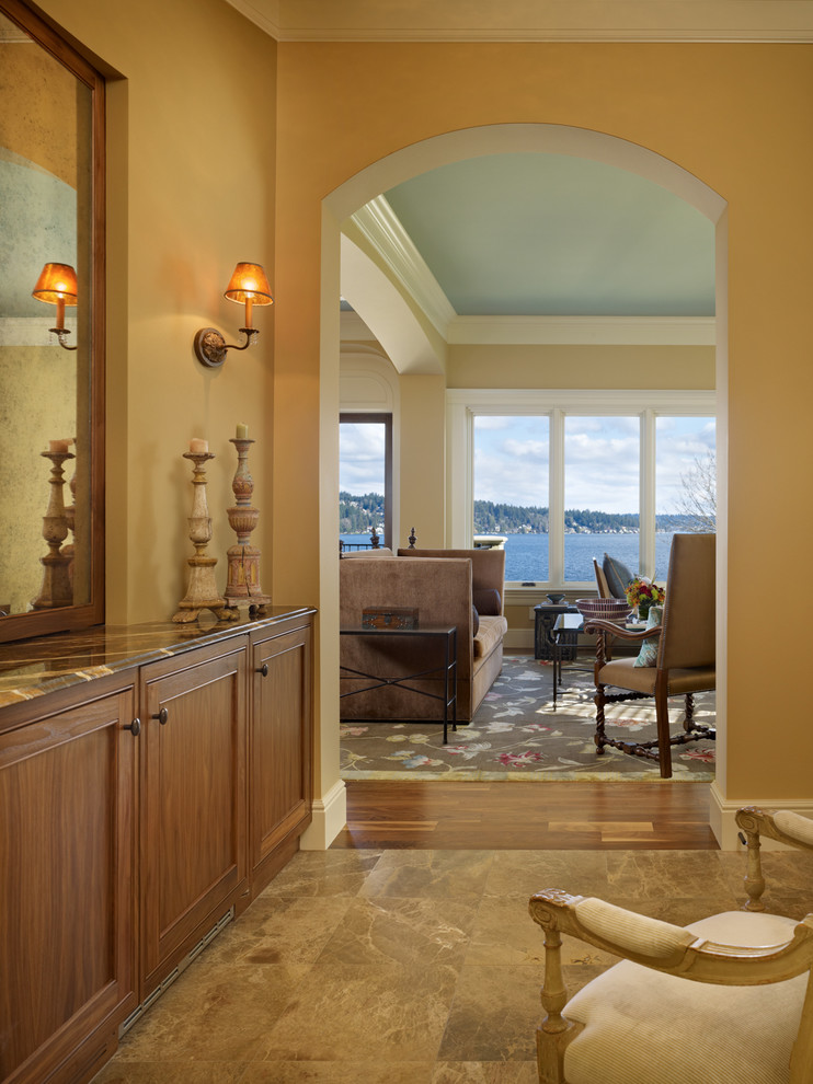 Entry hall - mid-sized mediterranean porcelain tile entry hall idea in Seattle with beige walls